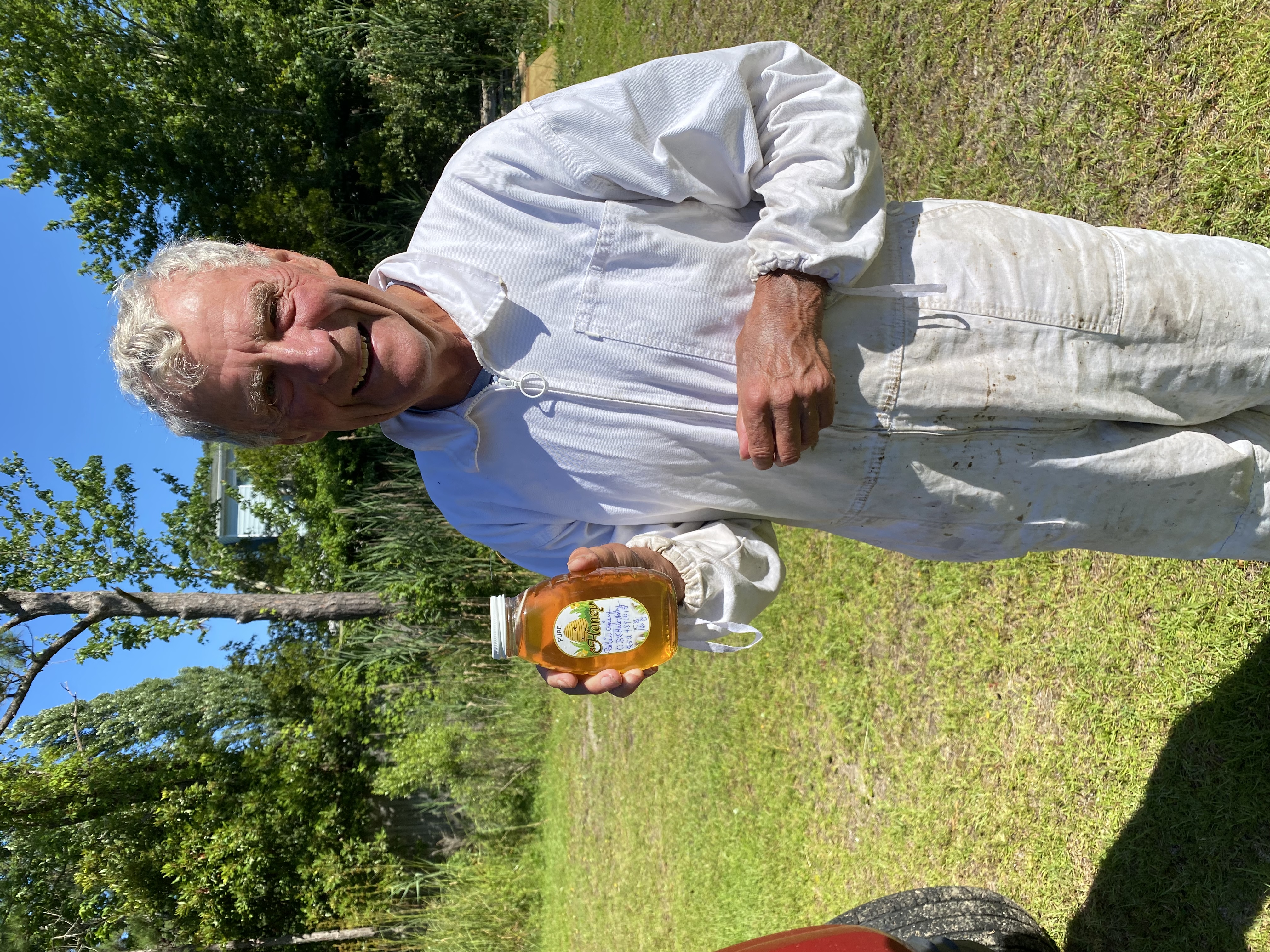 Don holding a jar of honey.