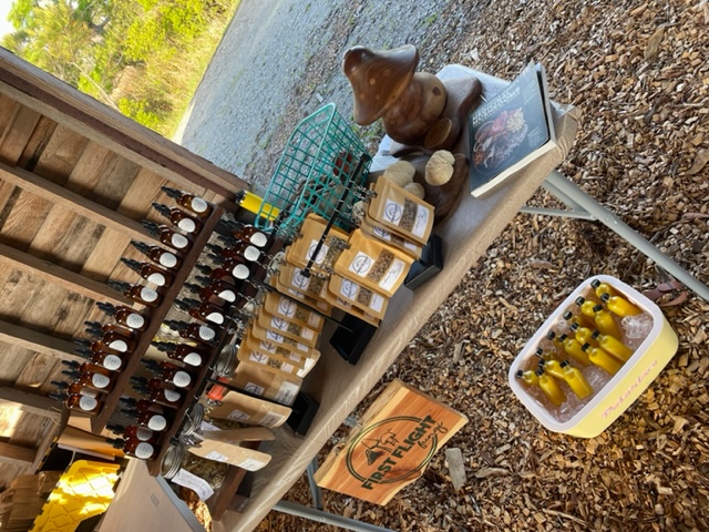 A table with various bottles and sealed packages displaying a market sign.