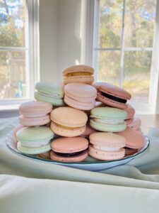 Macarons in a pile on a table.